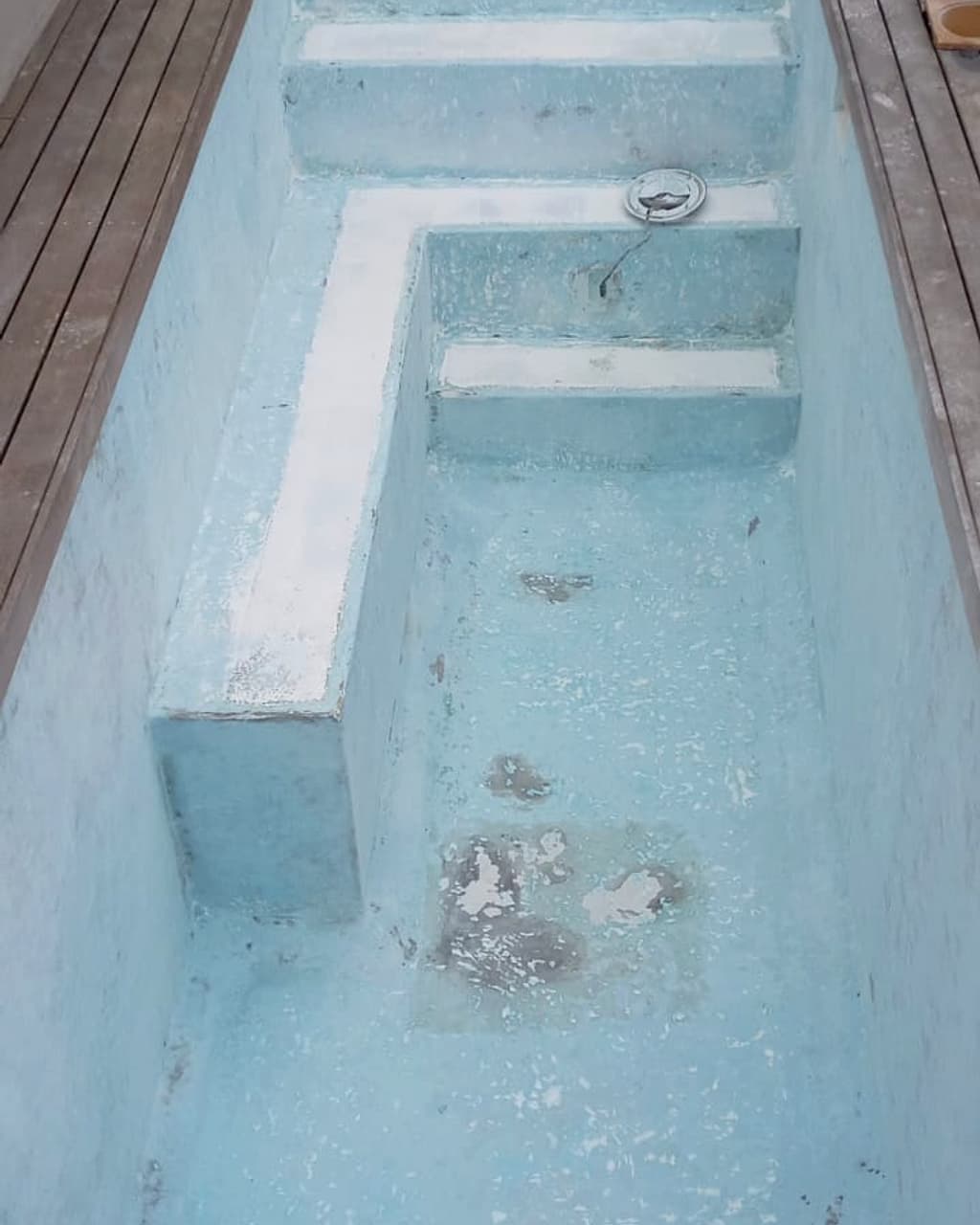 Pool interior stripped to bare concrete, old surface removed