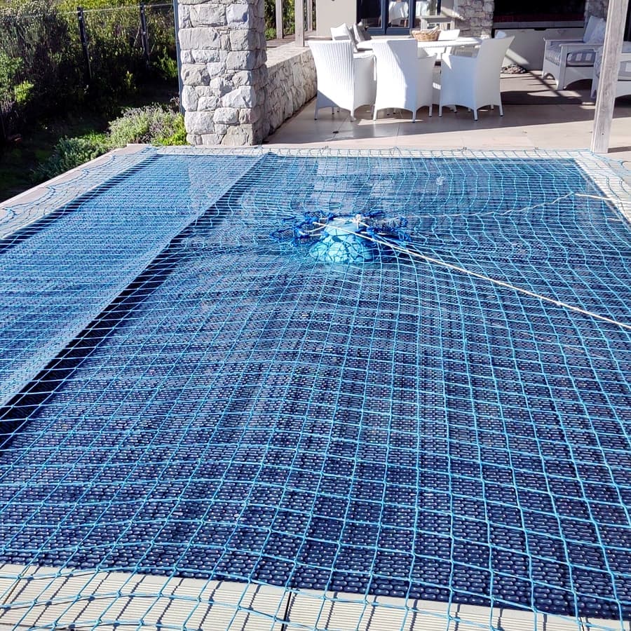 A custom-fitted pool cover sitting flush to the pool edge